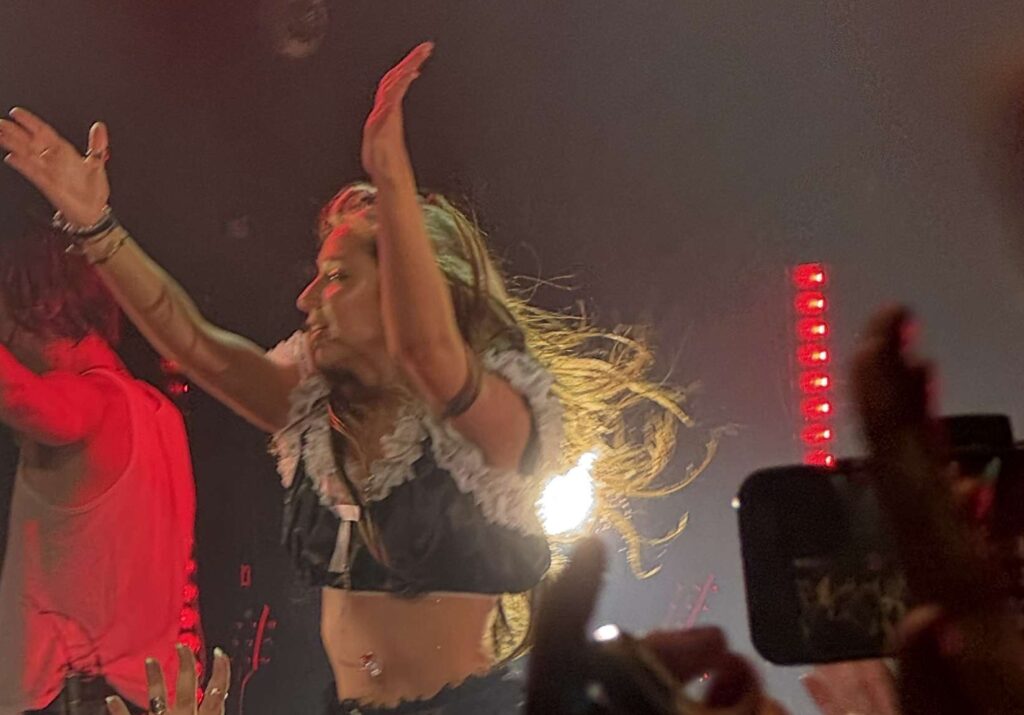 Isabel Larosa au concert Psychopump Tour avec les bras vers le haut